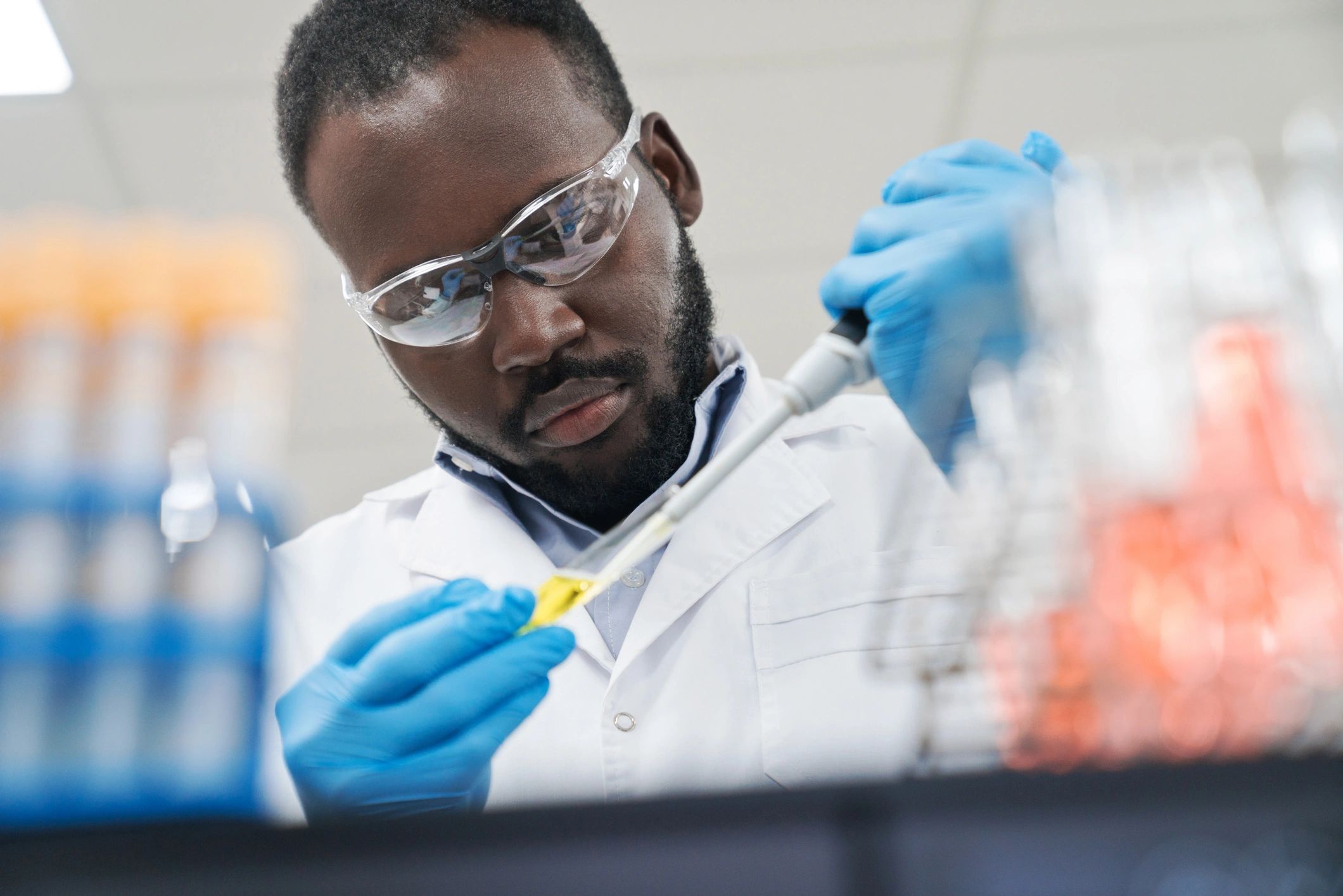 Scientist pipetting in a sterile lab environment representing controlled handling