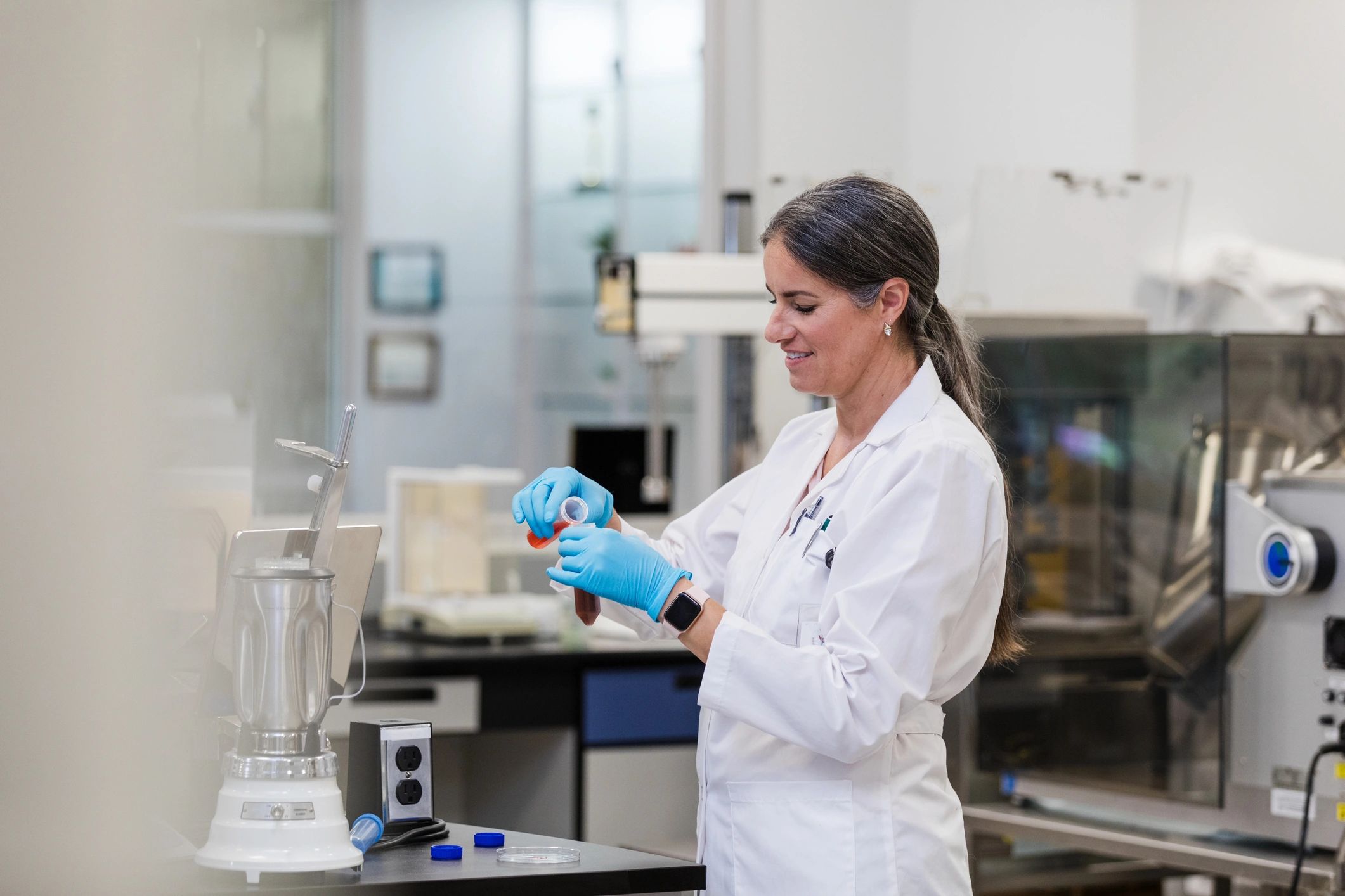 Scientist holding test tubes representing quality-focused laboratory work