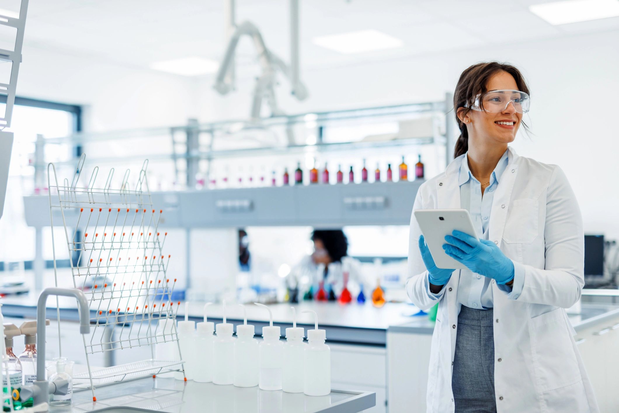 Scientist using a digital tablet in a modern laboratory representing efficient documentation review